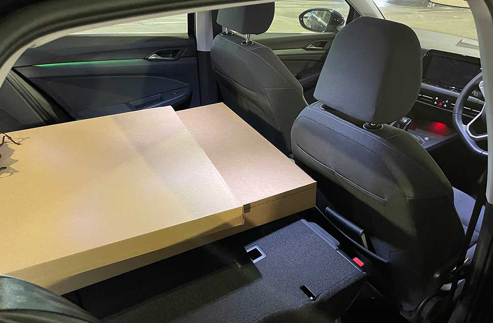 Photo of a large box inside the car, with the rear seats folded down.